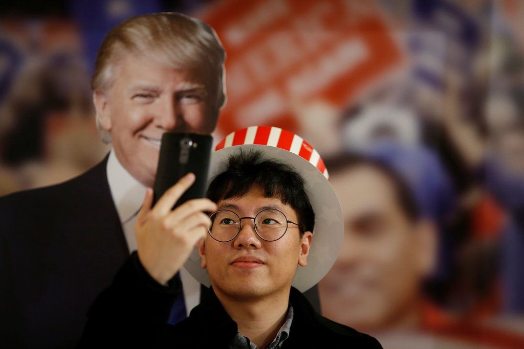 A man takes a selfie with a cut-out of Republican U.S. presidential nominee Donald Trump during a U.S. Election Watch event hosted by the U.S. Embassy at a hotel in Seoul, South Korea, November 9, 2016. REUTERS/Kim Hong-Ji