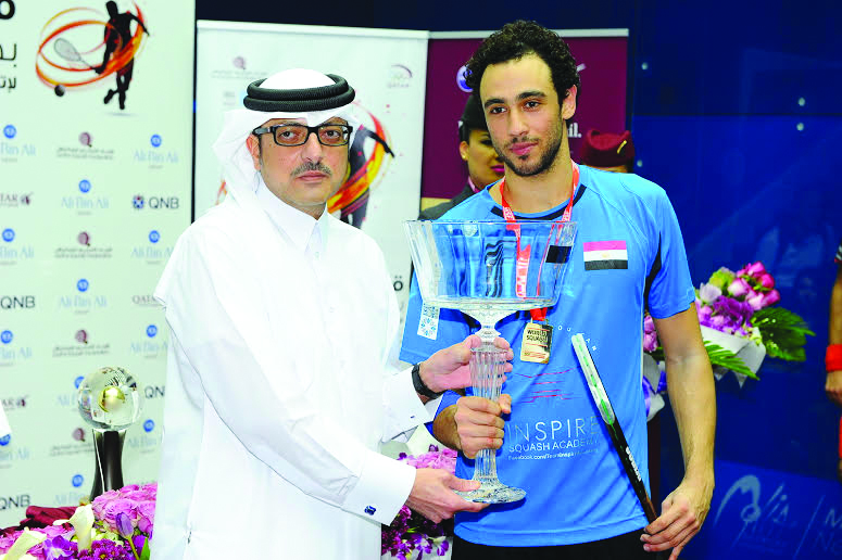 PSA World Championship winner Ramy Ashour is seen with Nabeel Ali bin Ali, President of Qatar Squash Federation after winning the world championship in Doha in this file picture of November 22, 2014.