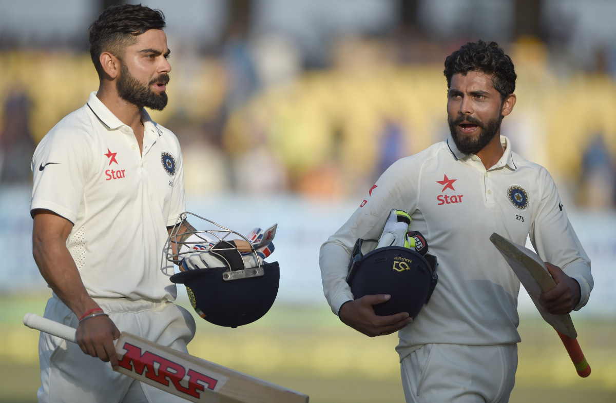India's captain Virat Kohli (L) and Ravindra Jadeja walk back at the end of play on the fifth day of the first Test cricket match between India and England at the Saurashtra Cricket Association stadium in Rajkot on November 13, 2016. (AFP / Indranil Mukhe