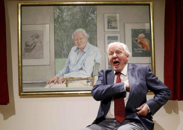 David Attenborough reacts next to a portrait of himself by Bryan Organ to mark his 90th birthday at New Walk Museum and Art Gallery in Leicester. Reuters