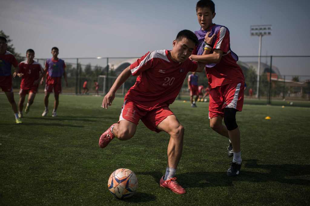 In a photo taken on September 22, 2016, students take part in an under-14 training session at the Pyongyang International Football School in Pyongyang. AFP / Ed Jones