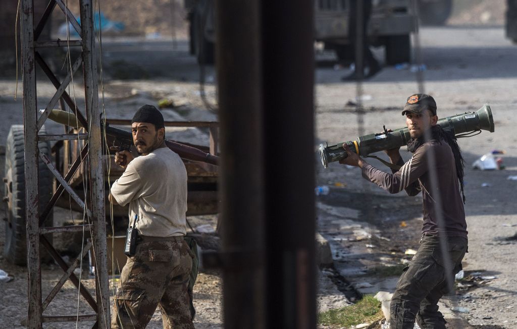 Soldiers from the Iraqi Special Forces 2nd division carrying rocket propelled grenades (RPG) and anti tank missiles take up positions to prepare for a suicide bomb vehicle that was reported to be moving towards their position as they engage with Islamic S