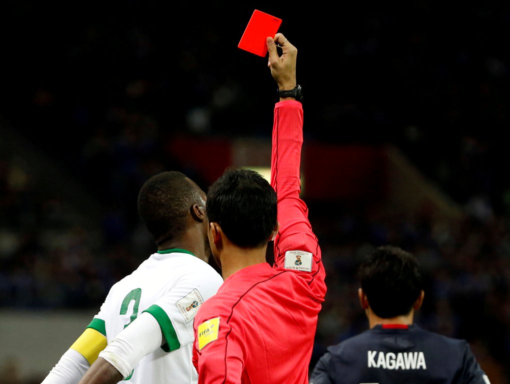 Saudi Arabia's Osama Hawsawi is shown a red card by referee Muhammad Taqi. REUTERS/Toru Hanai