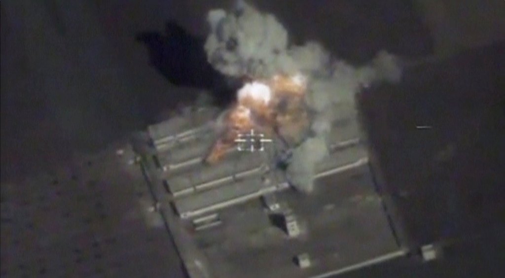 A still image taken from a drone footage and released by Russia's Defence Ministry on November 15, 2016, shows missiles hitting what Defence Ministry said was militants' ammunition warehouse at an unknown location in Syria. Ministry of Defence of the Russ