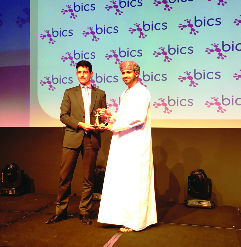 An Ooredoo official receiving the award.