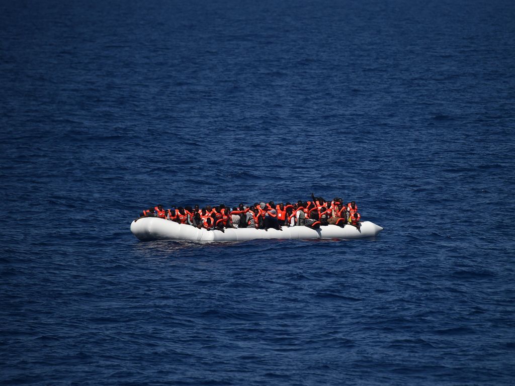 (FILES) This file photo taken on May 24, 2016 shows refugees waiting on a rubber boat to be rescued during an operation at sea with the Aquarius, a former North Atlantic fisheries protection ship now used by humanitarians SOS Mediterranee and Medecins San