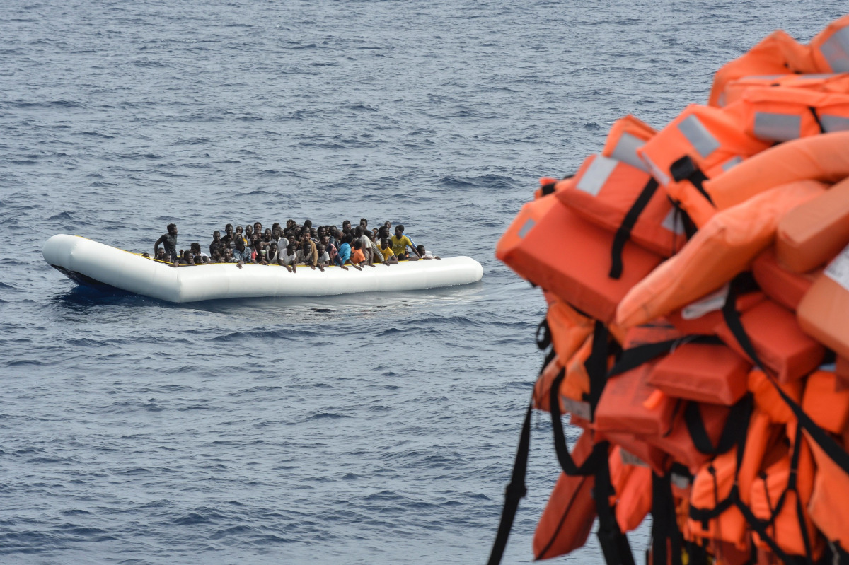 This file photo taken on November 5, 2016 shows migrants and refugees on a rubber boat waiting to be evacuated during a rescue operation by the crew of the Topaz Responder, a rescue ship run by Maltese NGO 