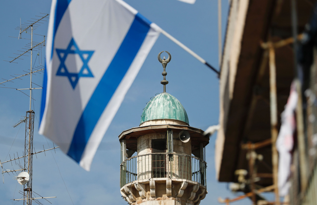 An Israeli flag waves in front of the minaret of a mosque in the Arab quarter of Jerusalem Old City on November 14 ,2016. (AFP) 