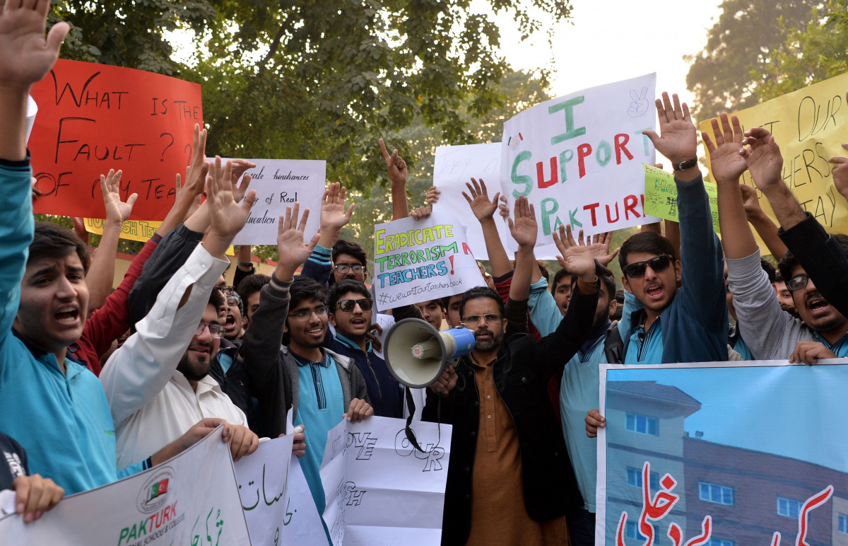 Pakistani students of the private PakTurk International Schools and Colleges shout slogans during a protest in Islamabad on November 17, 2016 against the Pakistani government's ordered deportation of 130 teachers. Pakistan has ordered the deportation of 1