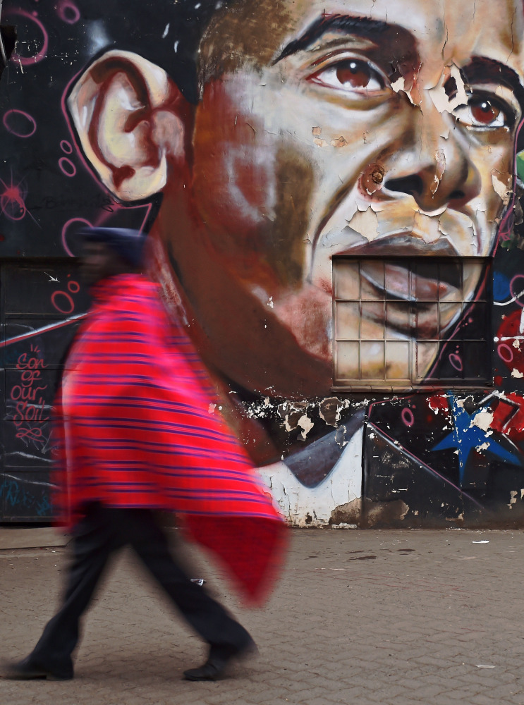 A man walks past a mural of US President Obama painted on a wall in Nairobi on November 8 2016 (AFP)