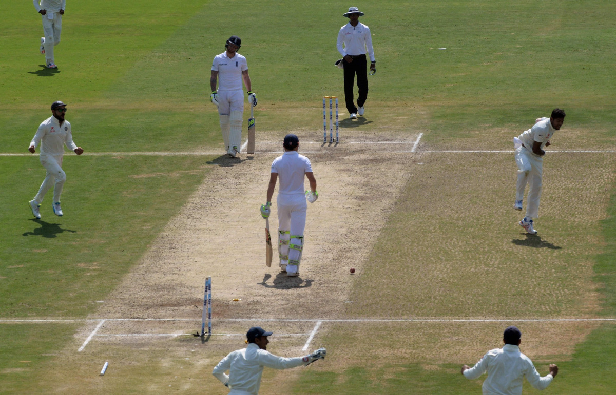 India's Umesh Yadav (R) celebrates the wicket of England's Jonny Bairstow (C) with captain Virat Kohli (L) and teammates during the third day of the second Test cricket match between India and England at the Dr. Y.S. Rajasekhara Reddy ACA-VDCA Cricket Sta