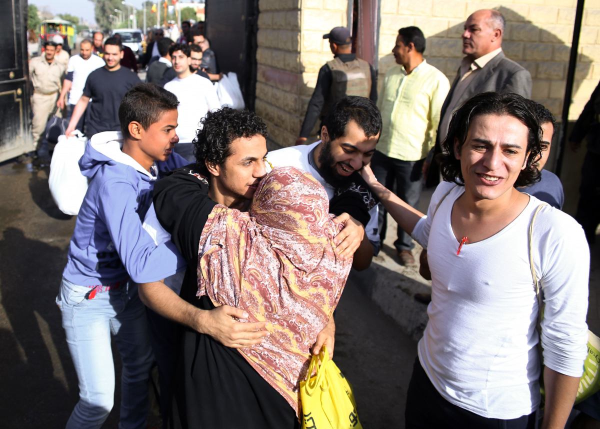 An Egyptian woman hugs a youth who was released from the capital Cairo's Tora prison on November 18, 2016. Egypt released today 82 detainees, more than 30 of them students, after a pardon was issued a day earlier by President Abdel Fattah al-Sisi followi