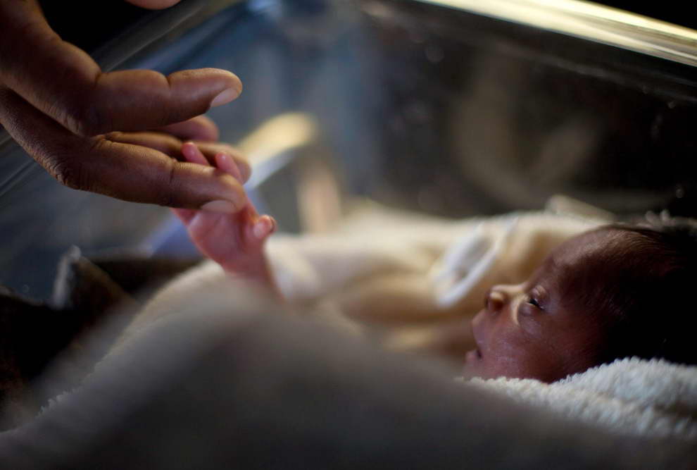 REPRESENTATIVE IMAGE: A man touches his newborn baby born three days earlier at the Israeli hospital in Port-au-Prince, January 20, 2010. (REUTERS /Carlos Garcia Rawlins) 