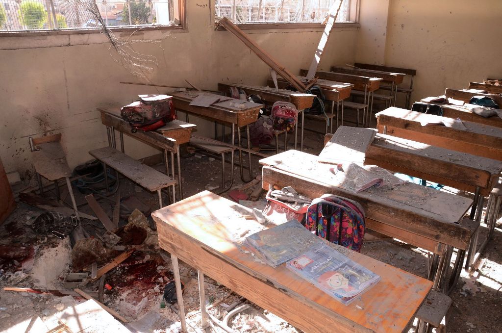 An image shows a pool of blood and damage at a classroom after it was reportedly hit by rebel rocket fire in the Furqan neighbourhood of the government-held side of west Aleppo, on November 20, 2016. / AFP.