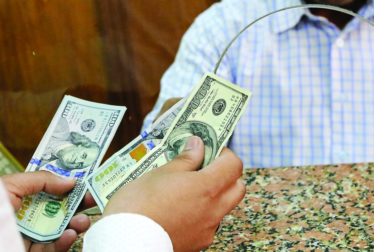 A customer exchanges US dollars to Egyptian pounds in a foreign exchange office in central Cairo. 
