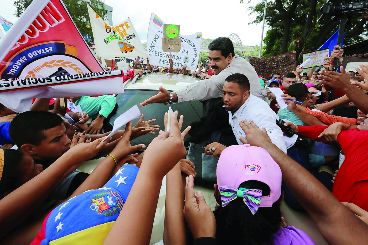 Venezuela's President Nicolas Maduro greets supporters as he arrives for his weekly broadcast 
