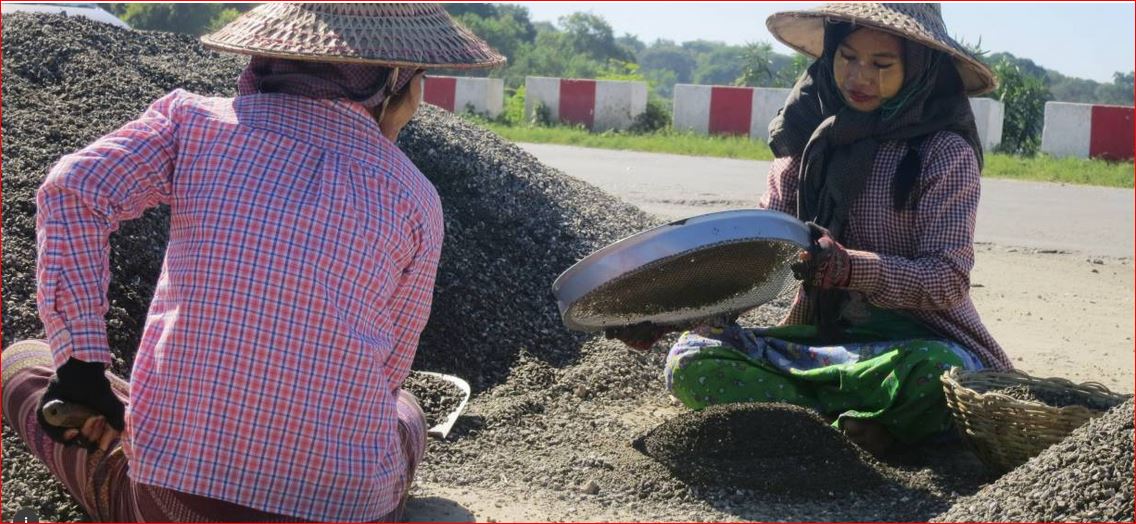 Women sort small rocks from bigger ones while building a road on the outskirts of Meiktila, central Myanmar, November 18, 2016. TRF/Zoe Tabary