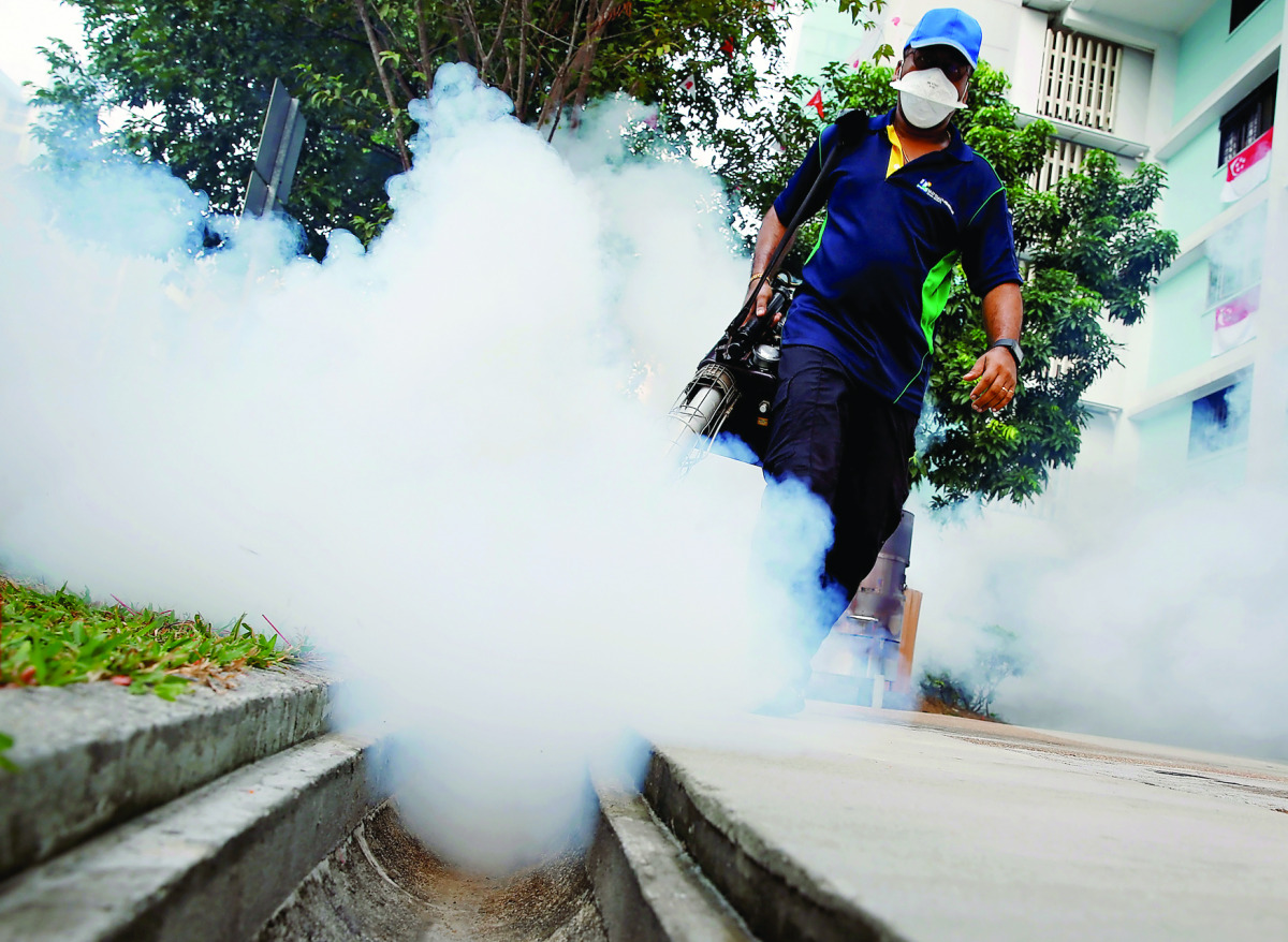 A worker fogs the common area of a public housing estate at a new Zika cluster in Singapore September 1, 2016. REUTERS/Edgar Su