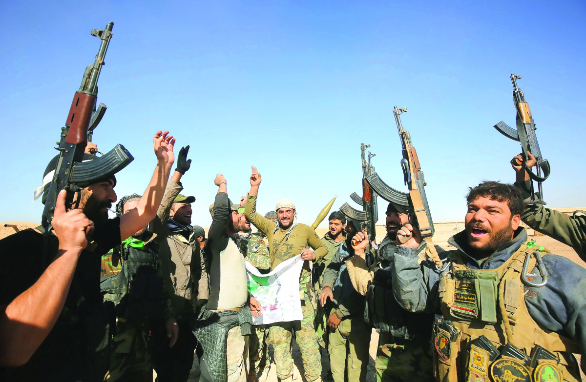 Fighters from the Hashed Al Shaabi (Popular Mobilisation) react as they enter the village of Al Tofaha, southeast of the city of Tal Afar, yesterday, during an ongoing operation against Islamic State (IS) militants. 