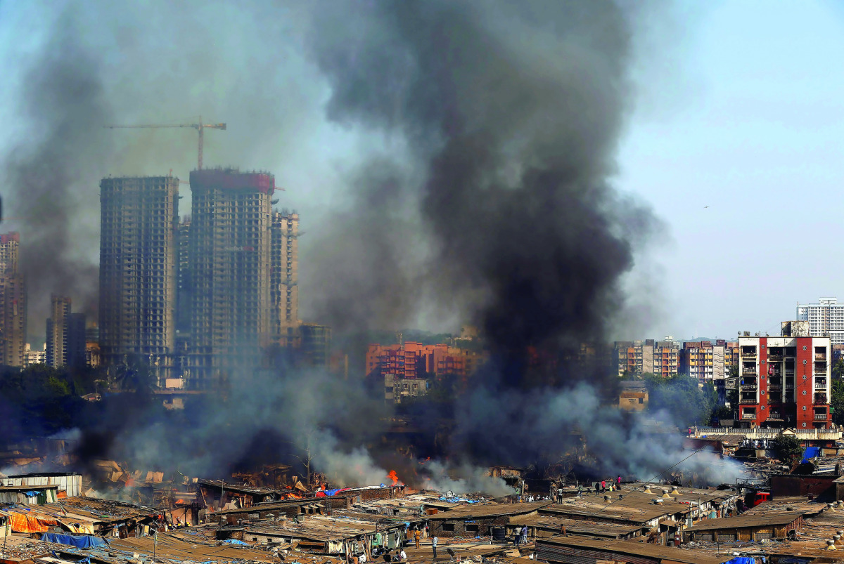 An aerial view shows smoke rising from a fire which broke out at a furniture market in Mumbai, India, November 25, 2016. REUTERS/Shailesh Andrade