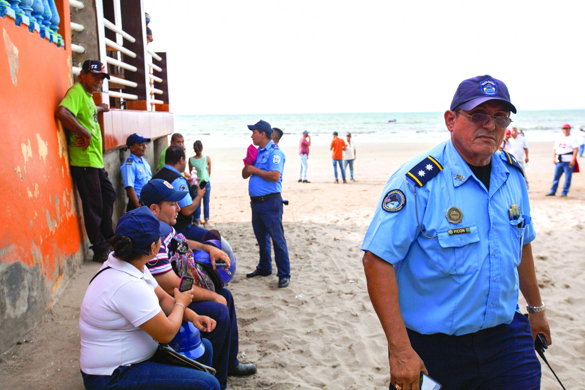 Police officers and residents of the Masacahapa seaside resort in the San Rafael del Sur municipality, Nicaragua. Central America suffered a hurricane and offshore earthquake yesterday, triggering alarm in Nicaragua, El Salvador and Costa Rica.