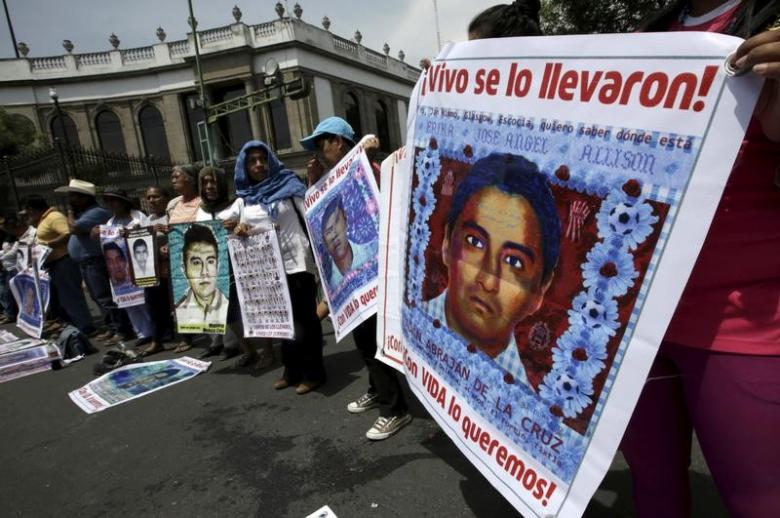 Relatives hold pictures of some of the 43 missing students of Ayotzinapa College Raul Isidro Burgos, as they take part in a protest to demand justice for the missing students, near the Interior Ministry in Mexico City, Mexico April 15, 2016. Reuters / Hen