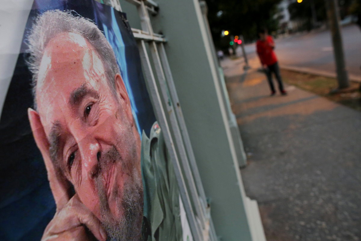 A picture of Fidel Castro as a local is seen on a wall as a resident walks along an empty street, following the announcement of the death of Cuban revolutionary leader, in Havana, Cuba November 27, 2016. REUTERS/Carlos Barria 