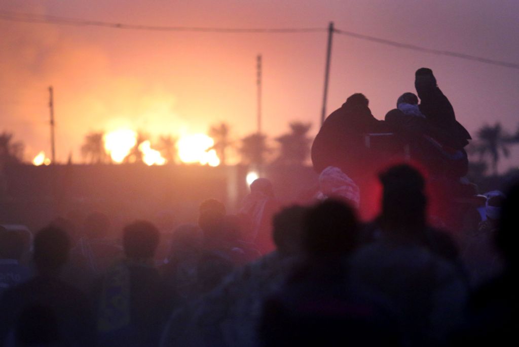 Iraqi men march in the southern city of Basra on October 27, 2016 during the funeral of four fighters from the Hashed al-Shaabi (Popular Mobilisation) paramilitaries, who were killed in battles against Islamic State (IS) group jihadists in the town of Tal