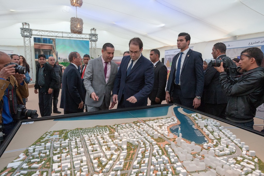 Tunisian Prime Minister Youssef Chahed (C) inspects a model during inauguration ceremony of Tunis Financial Port project in El-Hsayen region of Governorate of Ariana, Tunisia on November 27, 2016.