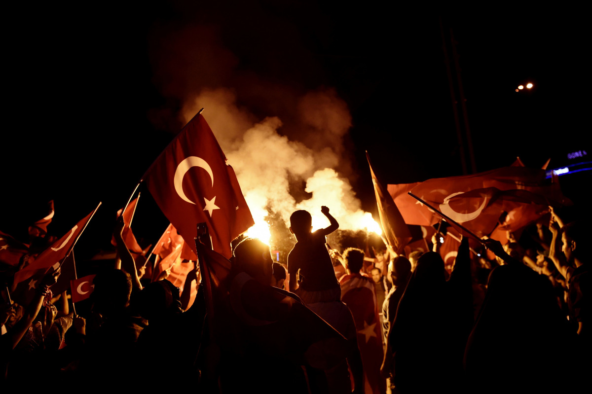 Pro-Erdogan supporters wave Turkish national flags during a rally at Taksim square in Istanbul on July 18, 2016 following the military failed coup attempt of July 15. Turkish security forces on July 18 carried out new raids against suspected plotters of t