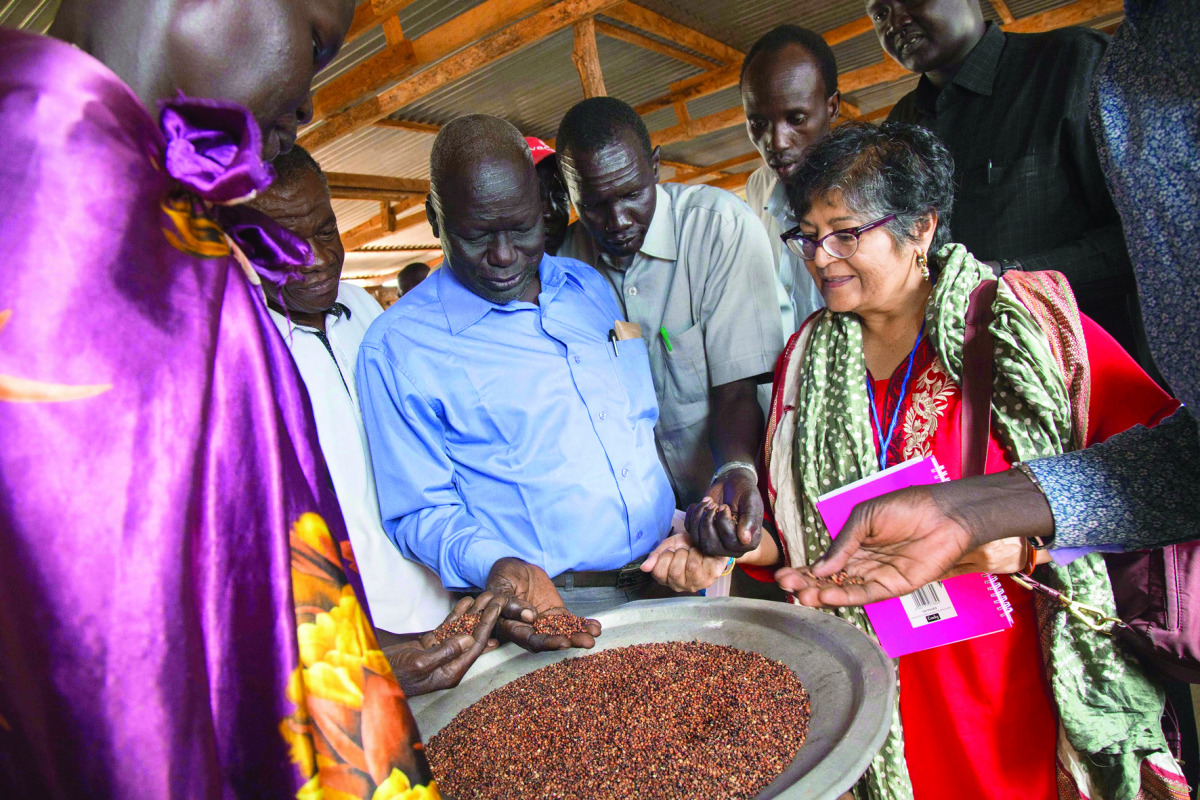Yasime Sooka, a member of the UN Commission on Human Rights, is shown a common staple of Sorghum by community leaders of the UN Protection of Civilians (PoC) site in Juba, South Sudan, yesterday. A group of three commissioners and their teams arrived in t