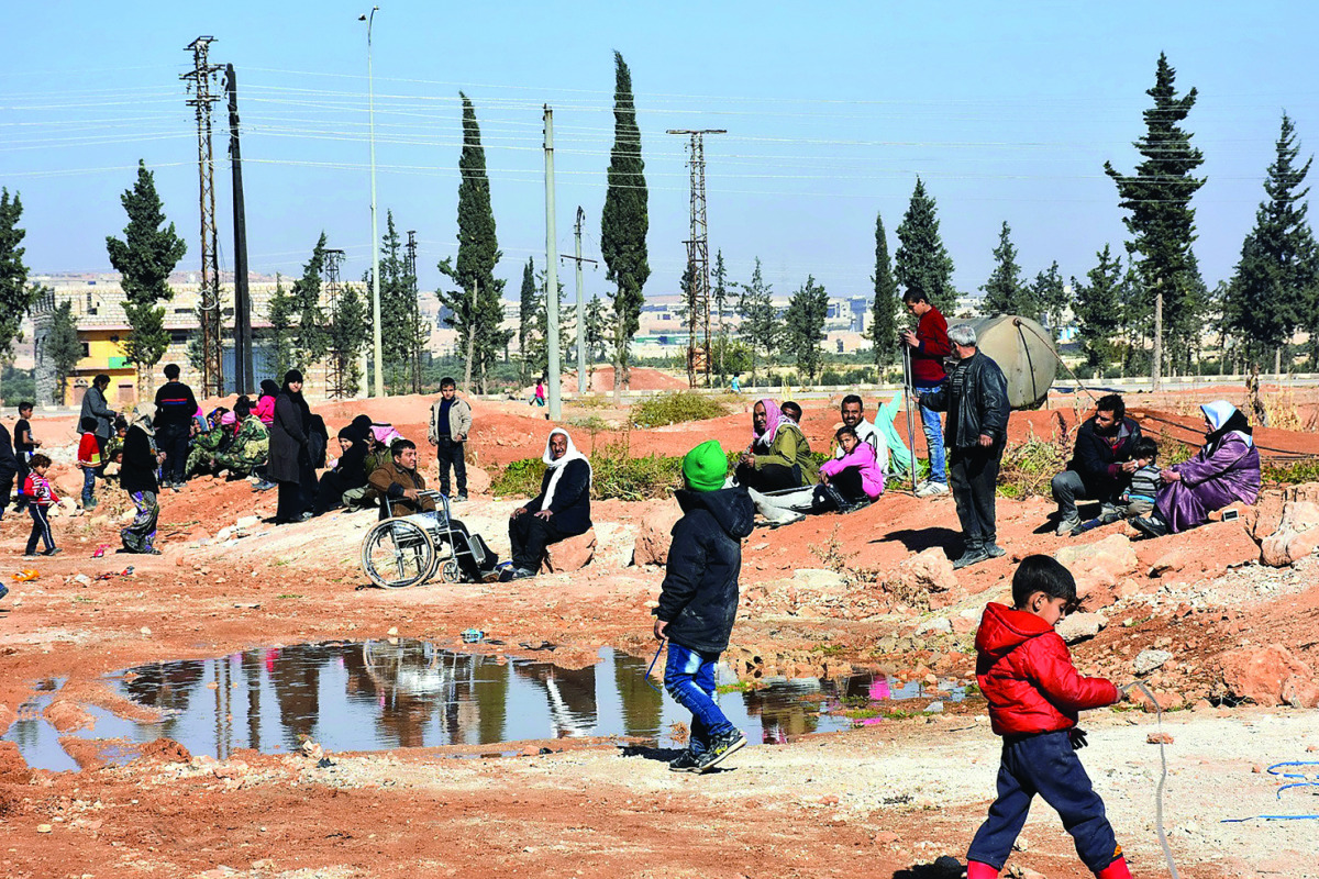 Syrians who evacuated the eastern districts of Aleppo are gathered in a government-held area in Aleppo, yesterday.