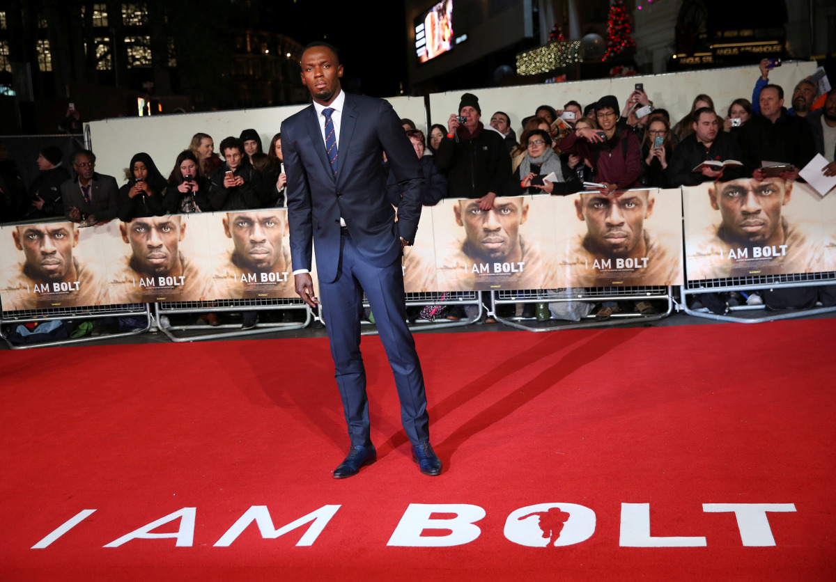 Athlete Usain Bolt (C) poses for photographers at the world premiere of the film 