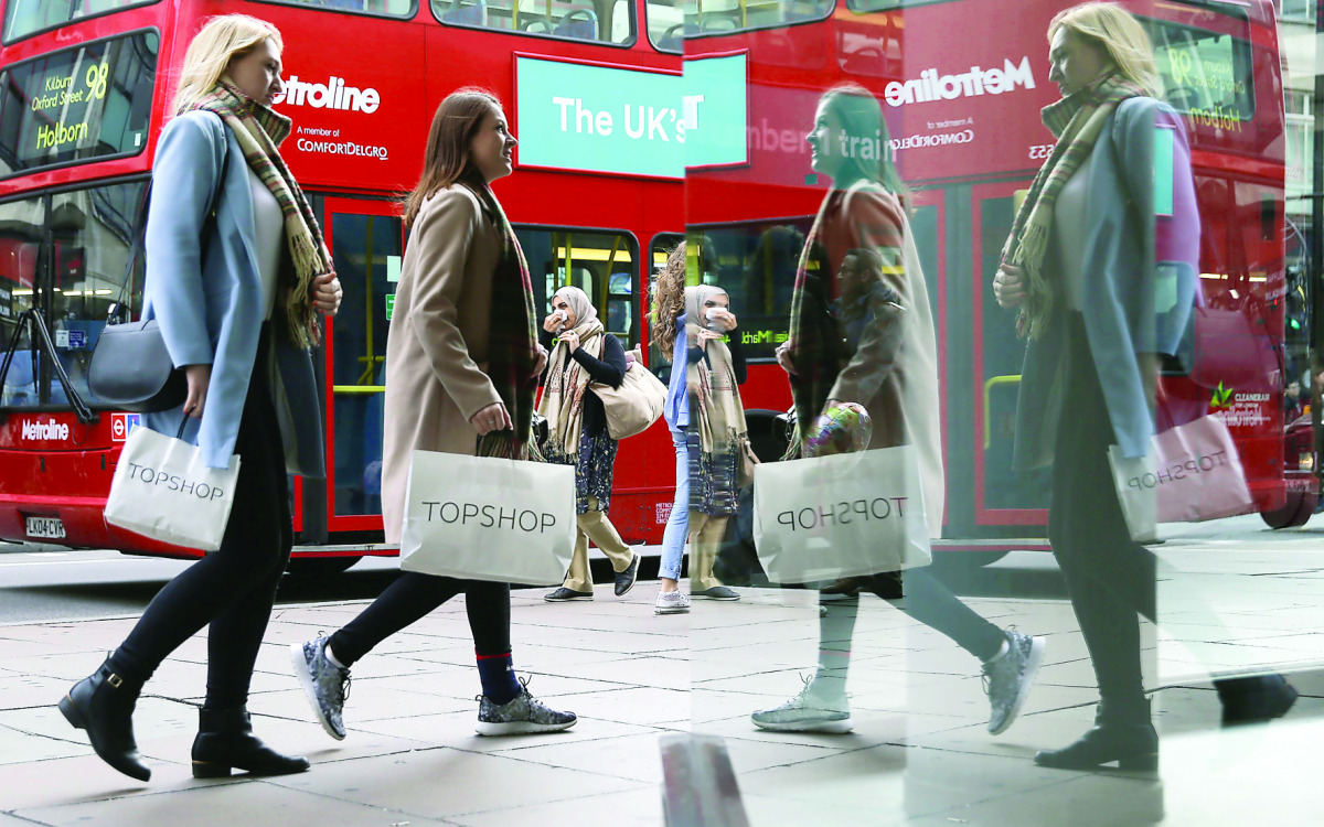 Pedestrians carrying shopping bags in Oxford Street in central London. 