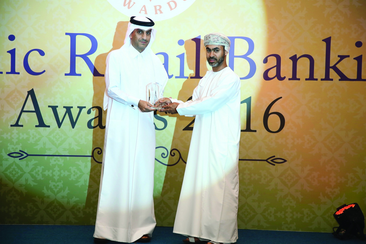 QIIB Deputy CEO Jamal Al Jamal (left) receiving the award at the event held in Dubai.