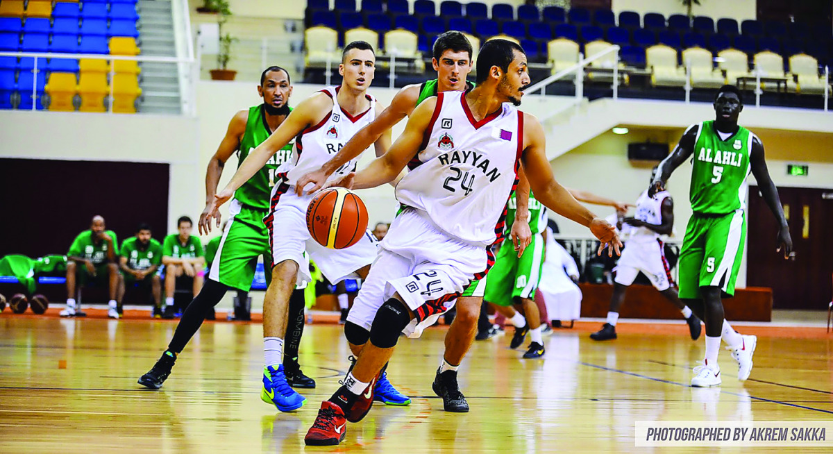 Al Rayyan's Mohamed Hassan dribbles the ball during their game against Al Ahli at Al Gharafa Sports Club Indoor Hall yesterday. Al Rayyan won by 93-75.