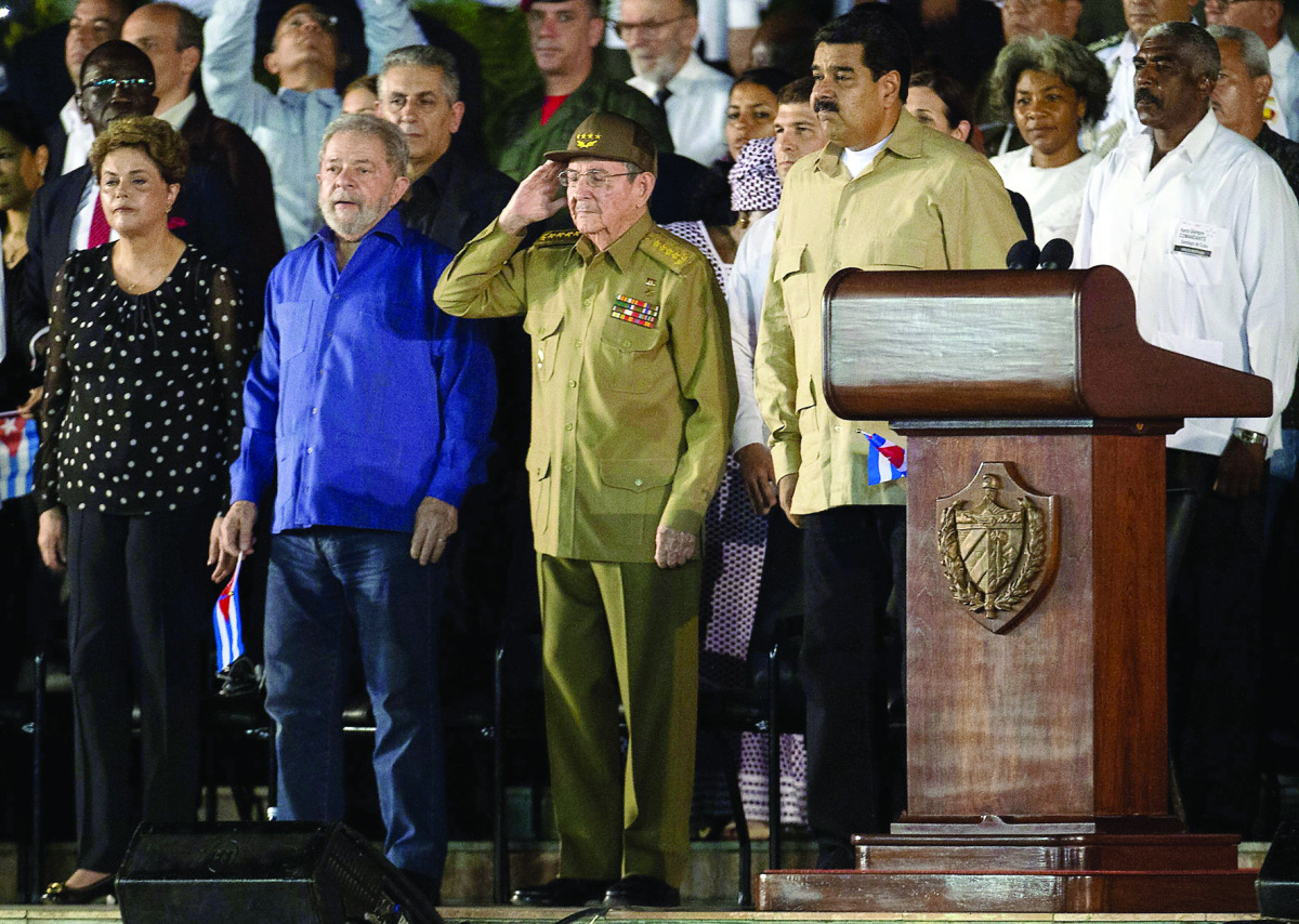 Cuban President Raul Castro salutes next to Venezuelan President Nicolas Mduro (R) and Brazilian former Presidents Dilma Rousseff (L) and Luiz Inacio Lula Da Silva, during the last ceremony to pay homage to the late Cuban leader Fidel Castro in Santiago, 