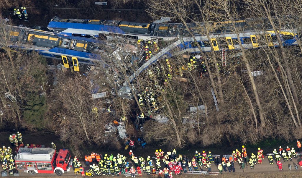 (FILES) This file photo taken on February 9, 2016 shows firefighters and emergency doctors working at the site of a train accident near Bad Aibling, southern Germany. A German court on December 5, 2016 sentenced a rail dispatcher to three and a half years