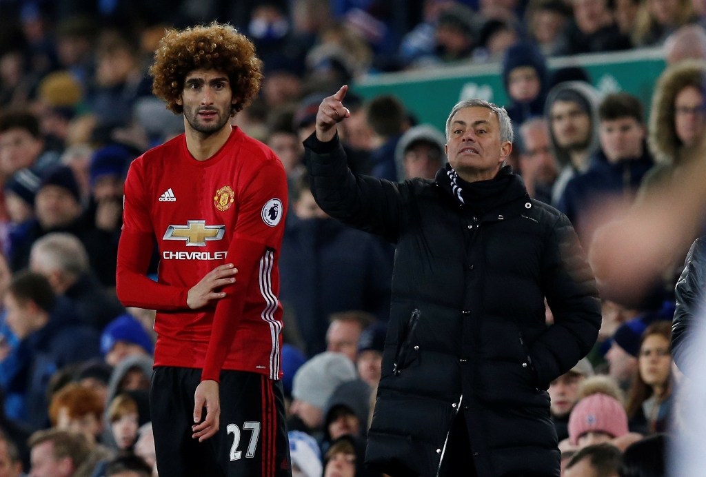 Manchester United's Marouane Fellaini prepares to come on as a substitute as manager Jose Mourinho looks on Reuters / Andrew Yates 
