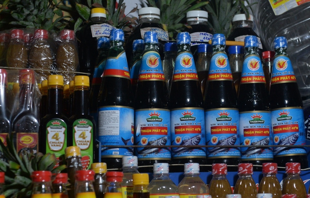 Bottles of fish sauce (in blue) are displayed for sale at a stand inside a local market in downtown Hanoi on Nov 21, 2016. PHOTO: AFP 
