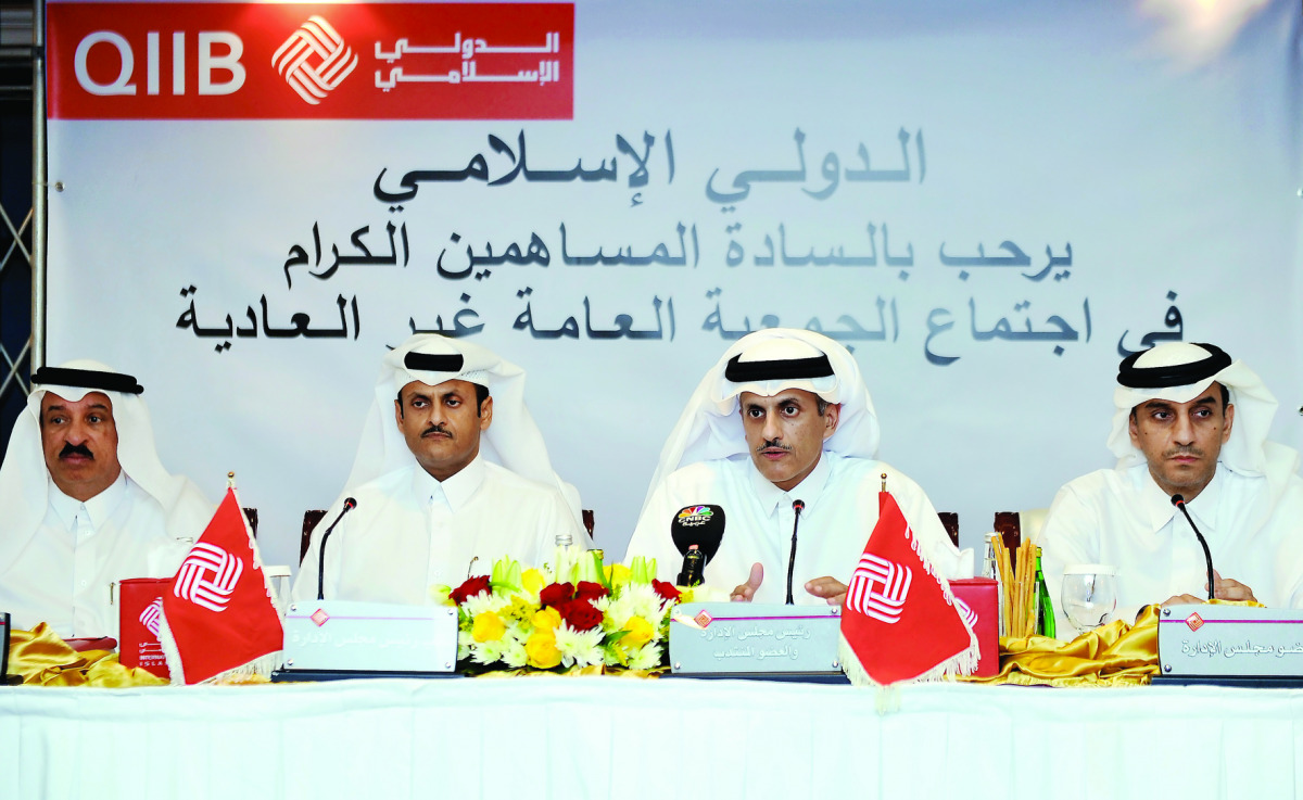 Sheikh Dr Khalid bin Thani bin Abdullah Al Thani, (third left) Chairman and Managing Director of QIIB, with Sheikh Abdullah bin Thani Al Thani (second left) Vice-Chairman of QIIB, and other Board Members during the Extraordinary General Assembly meeting i