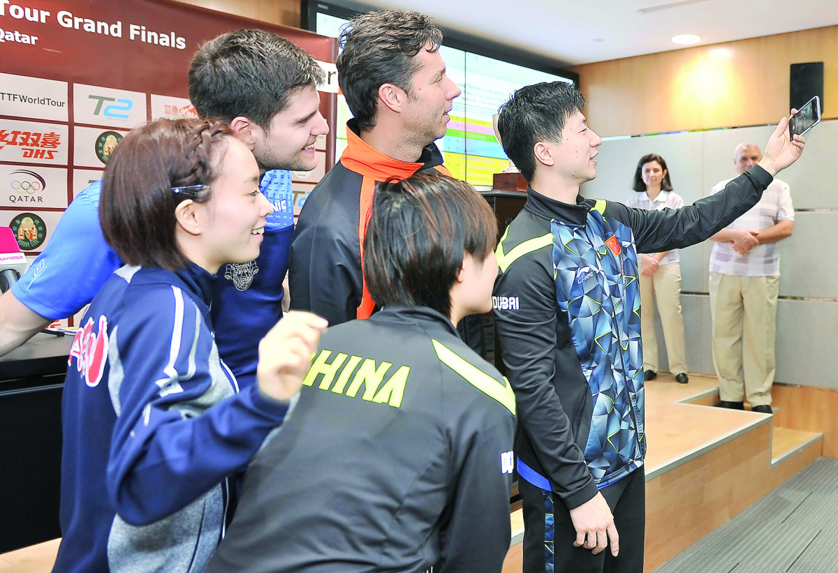 The players taking part in the 2016 ITTF World Tour Finals snap a selfie during the draw ceremony at Ali bin Hamad Al Attiyah Arena in Doha yesterday. The top 15 players, men and women, besides one man and one woman from the host country Qatar will be see
