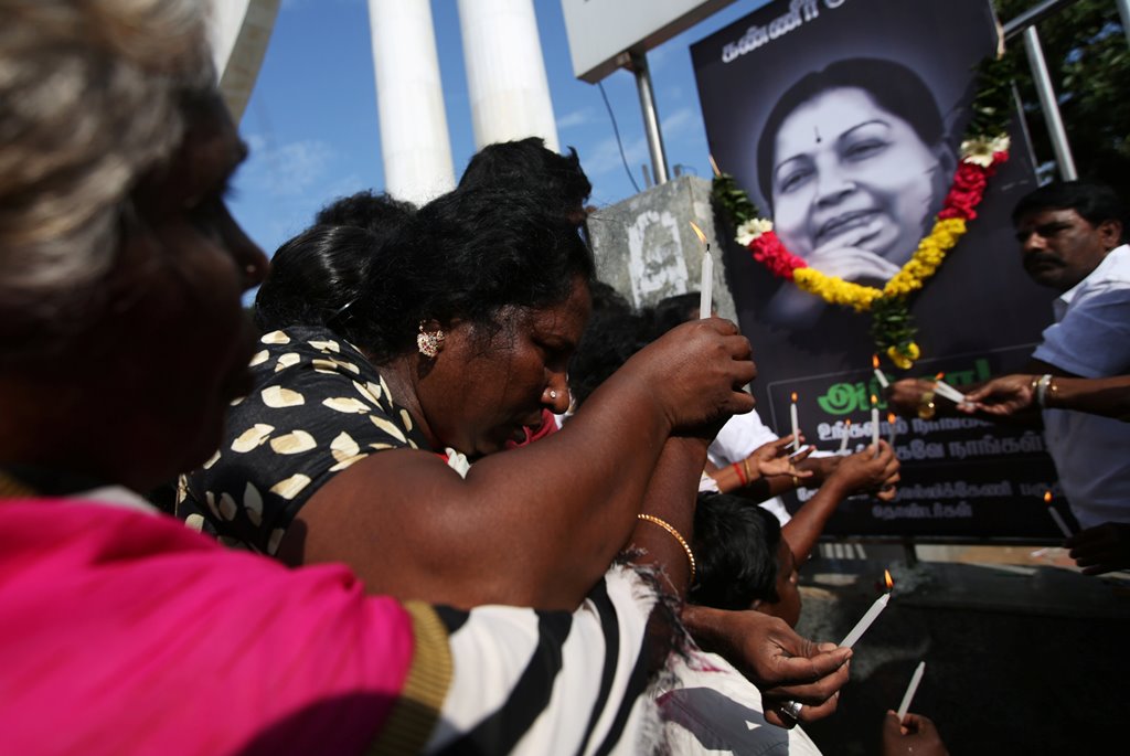 Supporters of Tamil Nadu Chief Minister Jayalalithaa Jayaraman light candles in front of her picture as they pay homage outside Jayalalithaa's burial site in Chennai, India, December 7, 2016. REUTERS/Adnan Abidi
