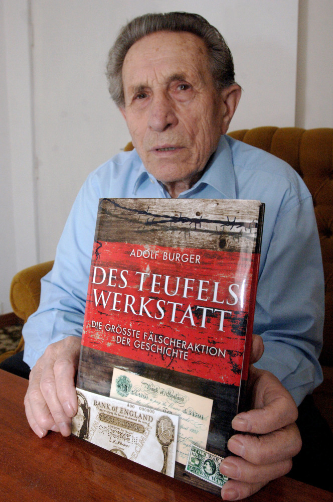 This file photo taken on February 23, 2007 shows Czech Adolf Burger, 89, a former prisoner in the Sachsenhausen concentration camp, showing his book 