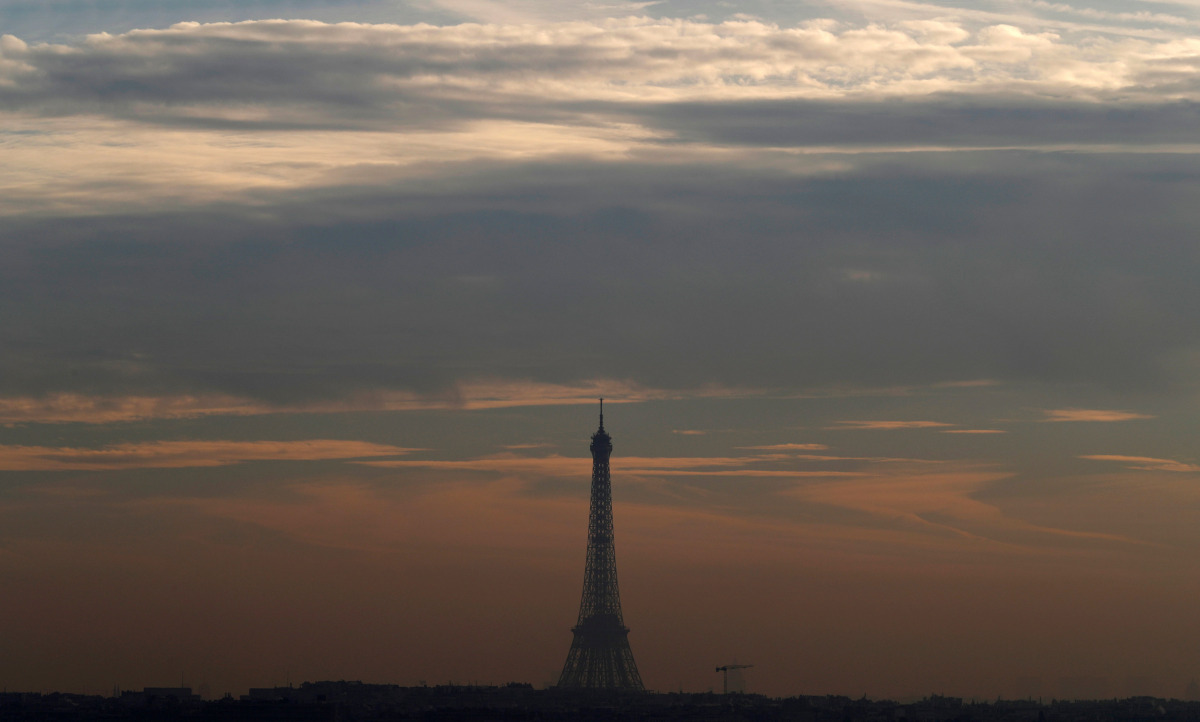 A small-particle haze hangs above the Eiffel Tower, that is seen on the horizon from Suresnes, near Paris, France, December 8, 2016. REUTERS/Christian Hartmann