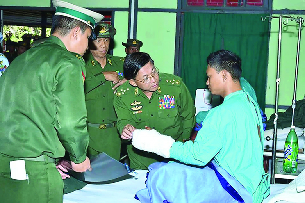 Myanmar Armed Forces chief Senior General Min Aung Hlaing meets a wounded soldier recovering at a military hospital in Lashio, located in Shan State.