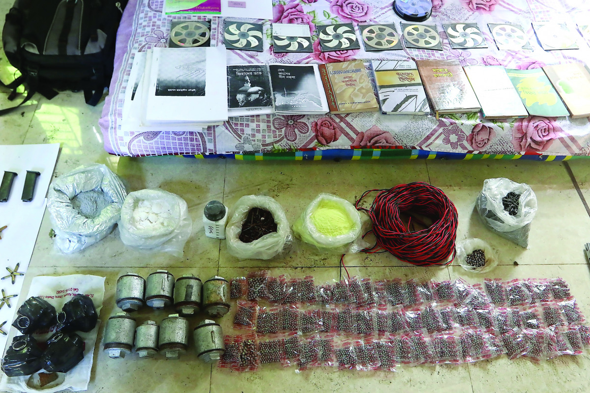 Explosive and explosive-making materials are displayed by the Rapid Action Battalion (RAB) after a raid on a banned Islamist extremist outfit, in Chittagong, yesterday.