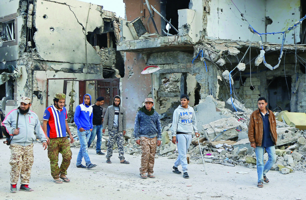 Forces loyal to Libya's UN-backed Government of National Accord (GNA) walk in the Al Giza Al Bahriya area in the former Islamic State (IS) group bastion of Sirte, yesterday.