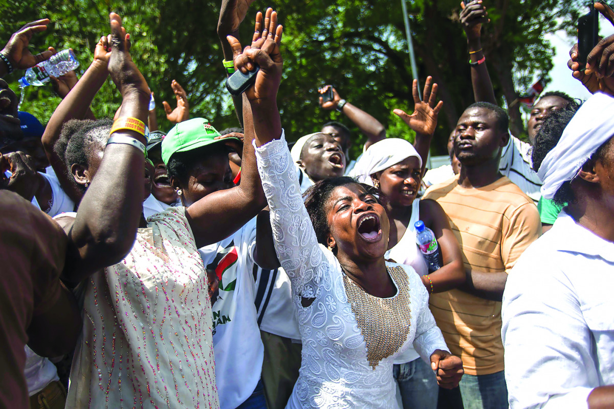 Supporters of the National Democratic Party (NDC) dance and cheer as they wait the results of the general elections, outside incumbent President John Mahama's house, in Labone, yesterday.