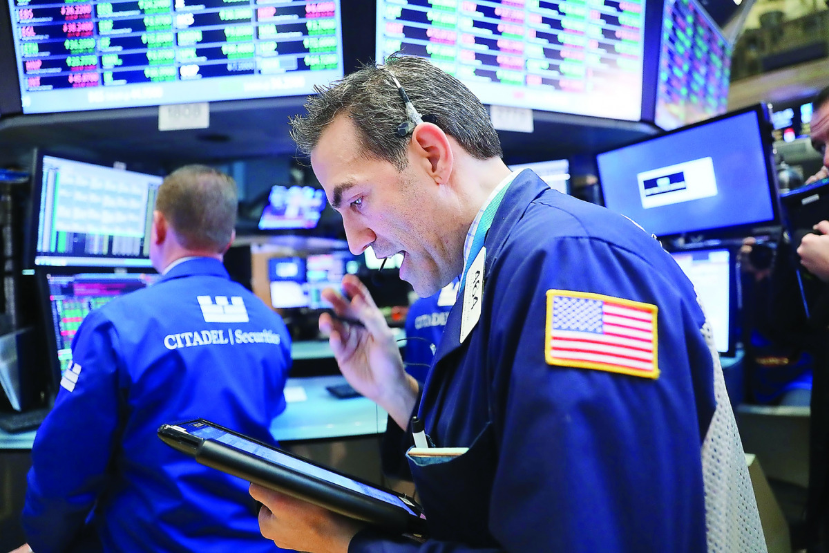 Traders work on the floor of the New York Stock Exchange .